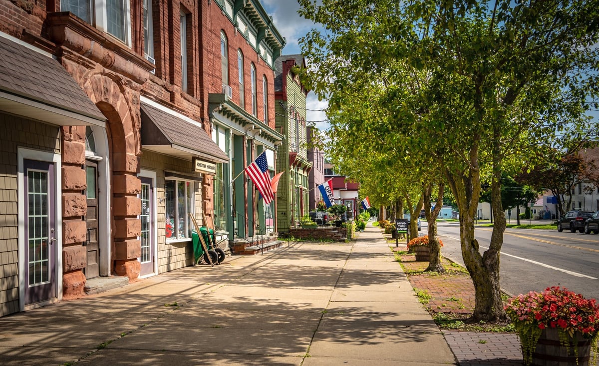 Main street small town storefronts on a summer day — a well-maintained website connects everyday business tasks with customer demand