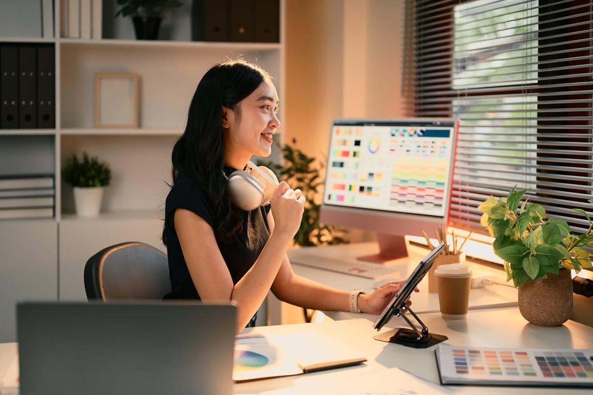 Female graphic designer using digital tablet in a modern workspace — brand design and creative identity concept