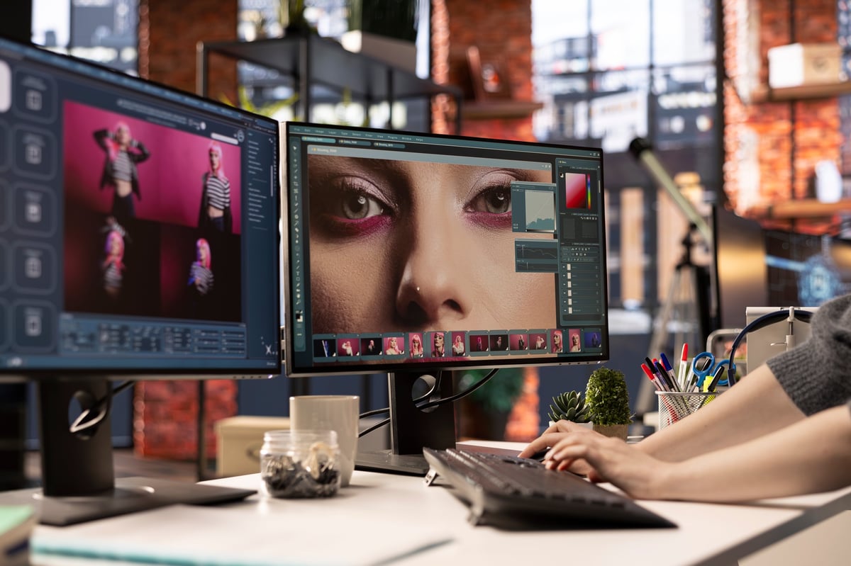 Graphic designer using laptop to edit brand visuals — creative professional working on brand identity