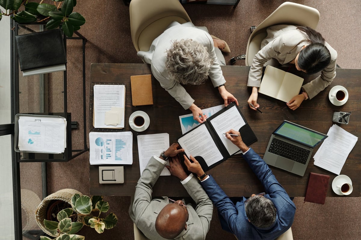Business professionals collaborating around a table — a simple checklist keeps online improvements manageable