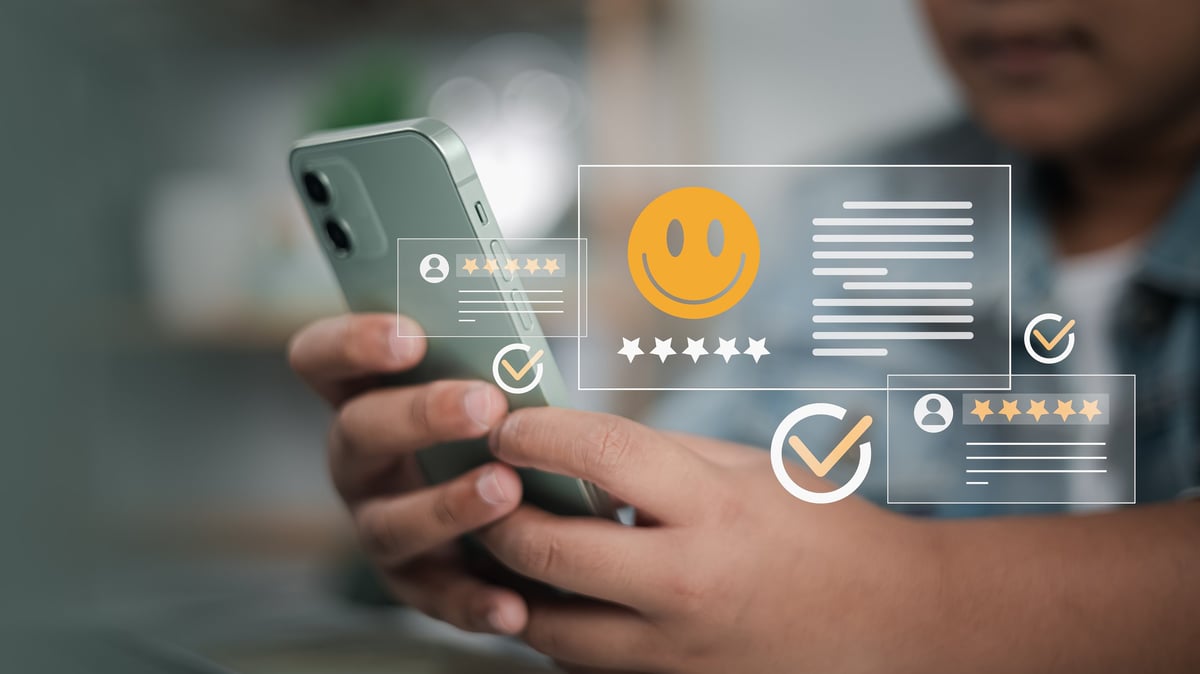 Customer using smartphone with online reviews and star ratings — reputation management shapes buying decisions before anyone makes contact