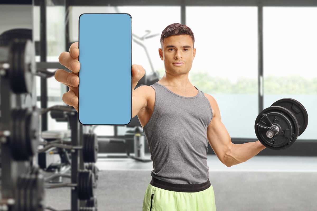 Member using the studio's branded app during a training session