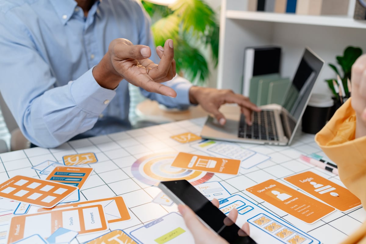 Designers presenting website wireframes and interface concepts during a workshop